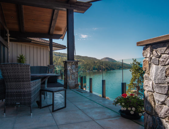 Covered Deck Overlooking Lake Stone Posts